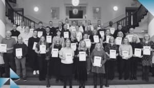 A group of people holding certificates