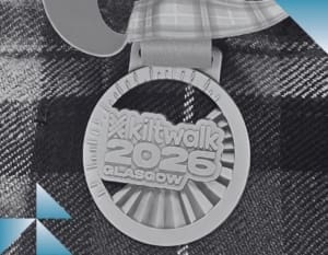 An image of a medal against a tartan background